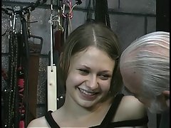 Cutie in bondage gets teased by aged fellow