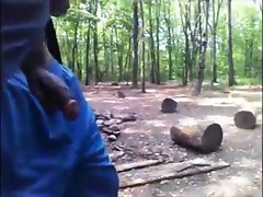 Ebony chap walks in woods with phallus out
