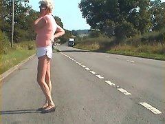 Nice looking Crossdresser flashing her dick on busy road.