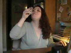 Attractive mature Obese drinks cum from a shot glass