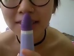 Asian lady rubs her pussy with a toy