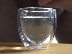 Creamy jizz in a shot glass of water