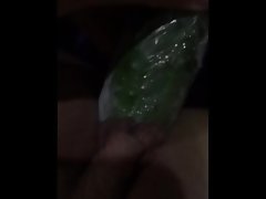 Raunchy teen masturbating with a cucumber